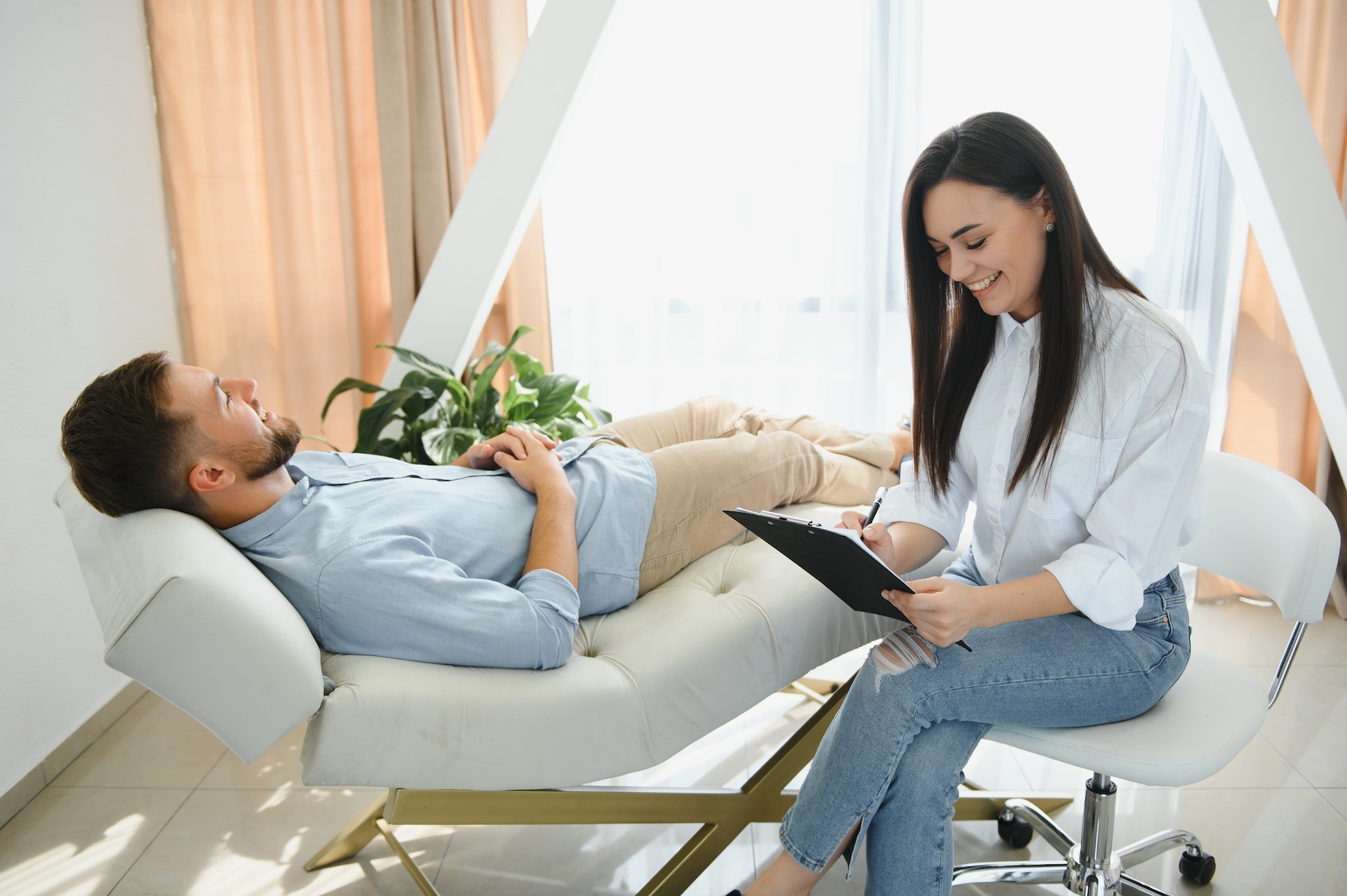 depressed-man-speaking-to-a-therapist-while-she-is-2025-03-18-05-50-56-utc