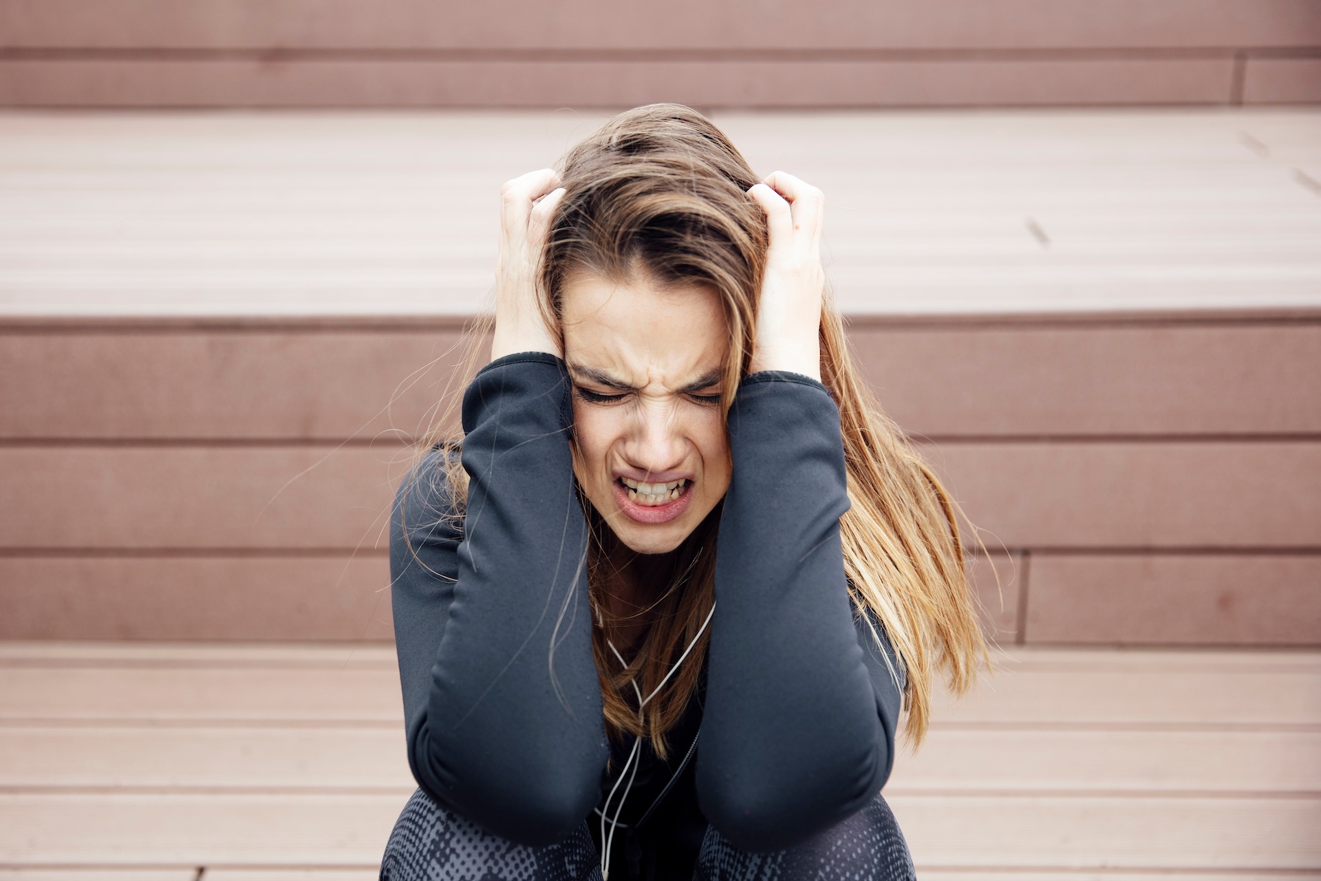 angry-sad-young-woman-sitting-outdoor-2023-11-27-04-57-45-utc