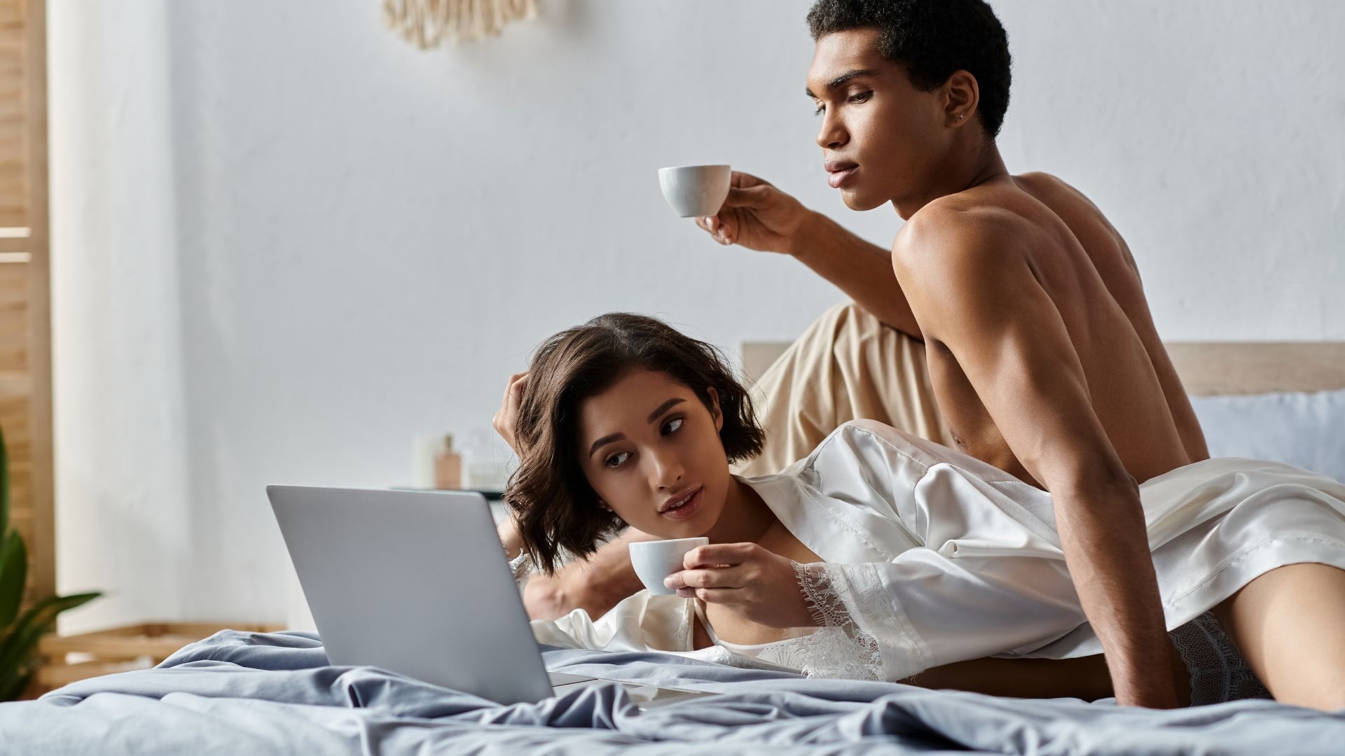 Porn addiction: man and woman in bed watching laptop. Porn addiction: man and woman in bed watching laptop.