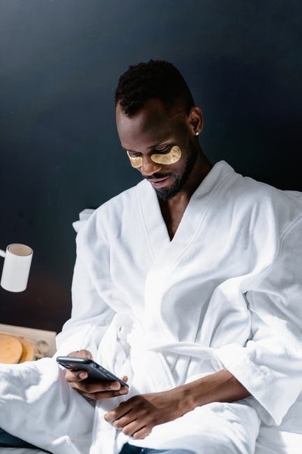 5 Ways That You Can Practice Self-Care PIcture of a man in bed in a robe, practicing self-care.