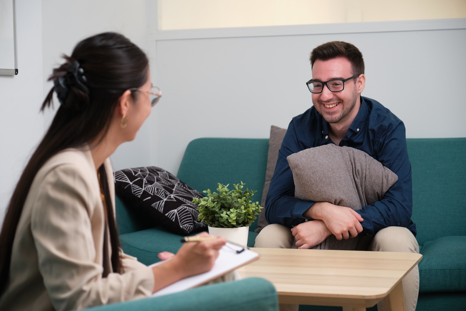 asian-female-psychologist-and-caucasian-man-patien-2025-03-13-11-54-00-utc