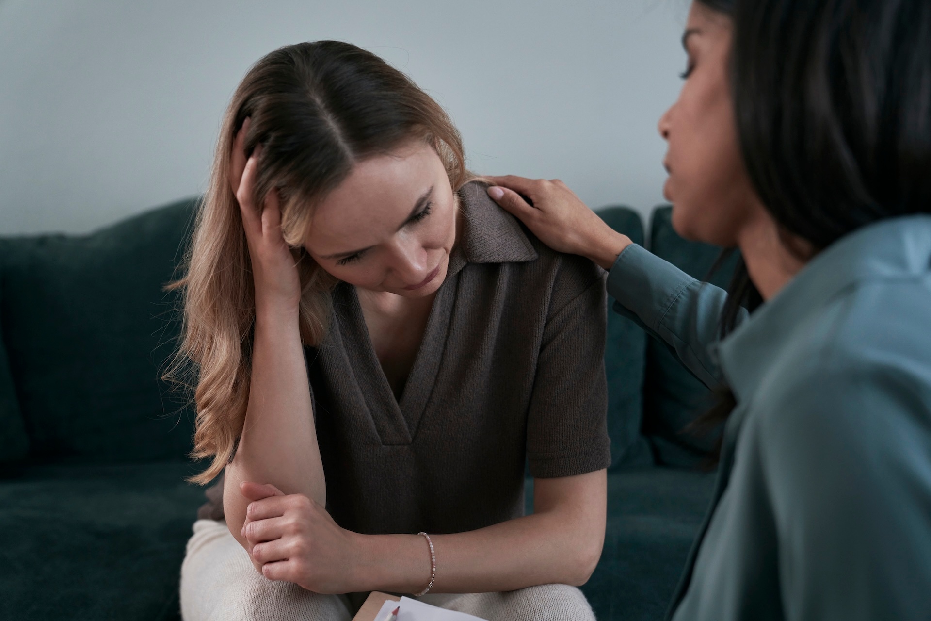 woman-consoling-her-female-patient-during-a-therapy-session woman-consoling-her-female-patient-during-a-therapy-session