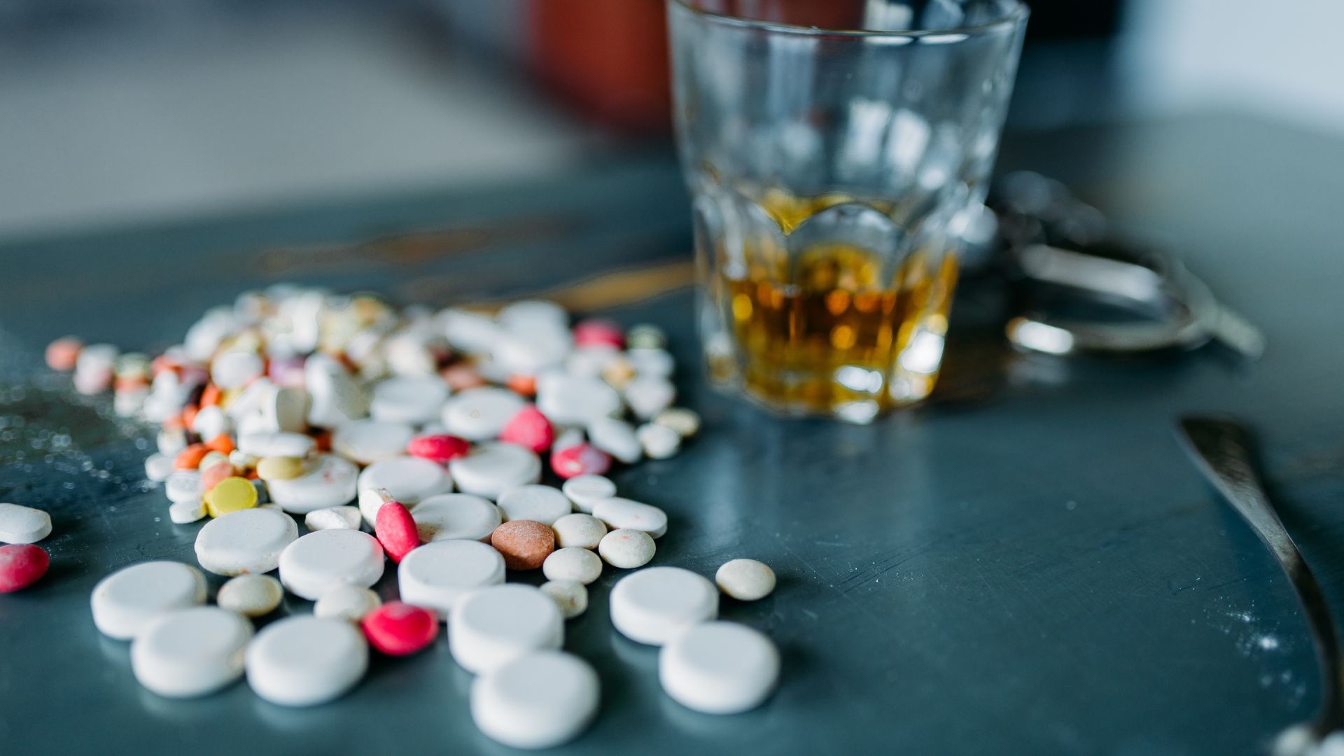 Signs of vyvanse addiction. Pills on the table with a drink Signs of vyvanse addiction. Pills on the table with a drink