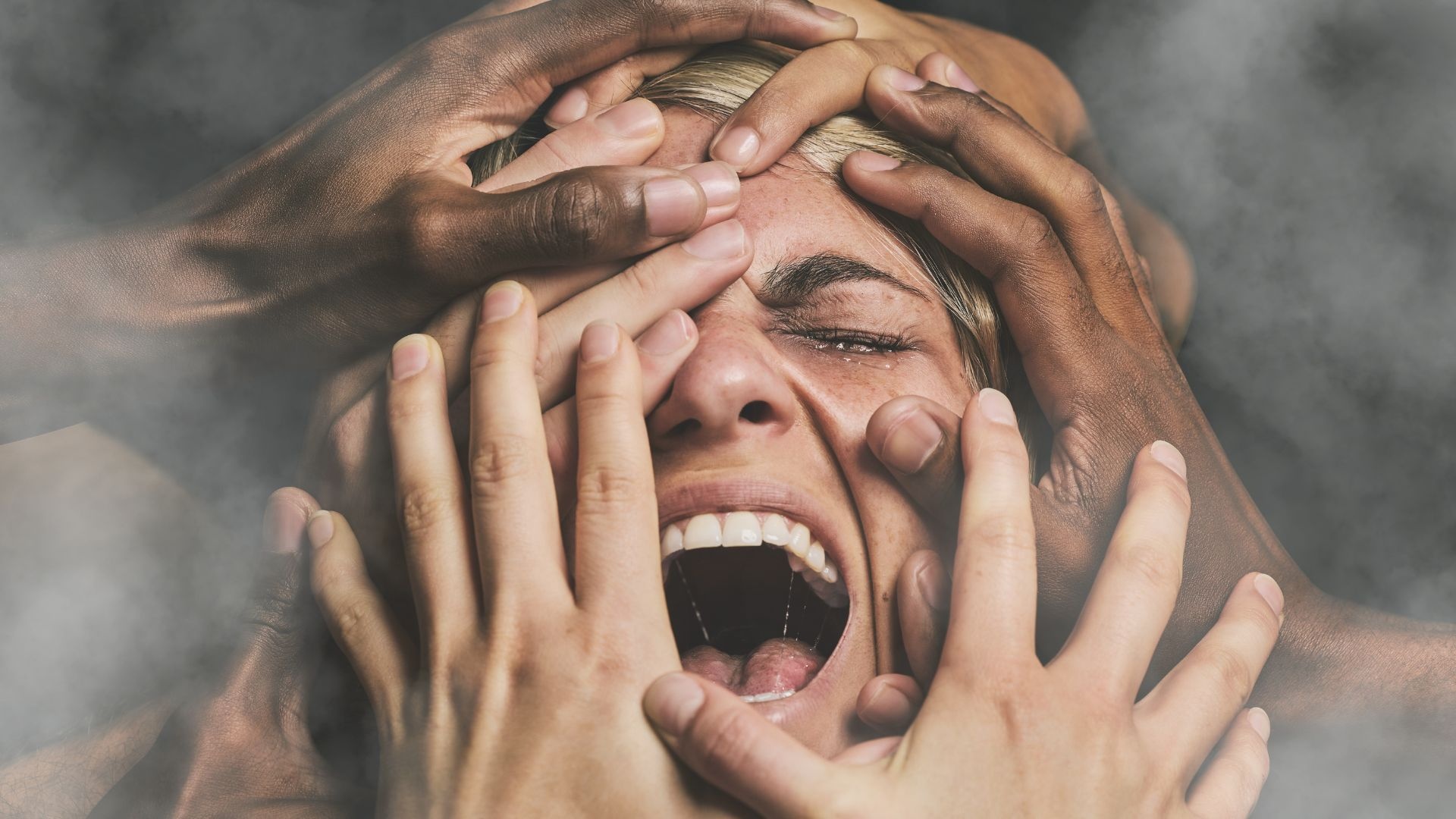 Emotional addiction: Depressed woman being grabbed by multiple hands with dark background Emotional addiction: Depressed woman being grabbed by multiple hands with dark background