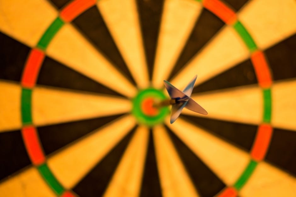 7 Steps to Set Achievable Goals Picture of a dartboard with a dart in the bullseye.