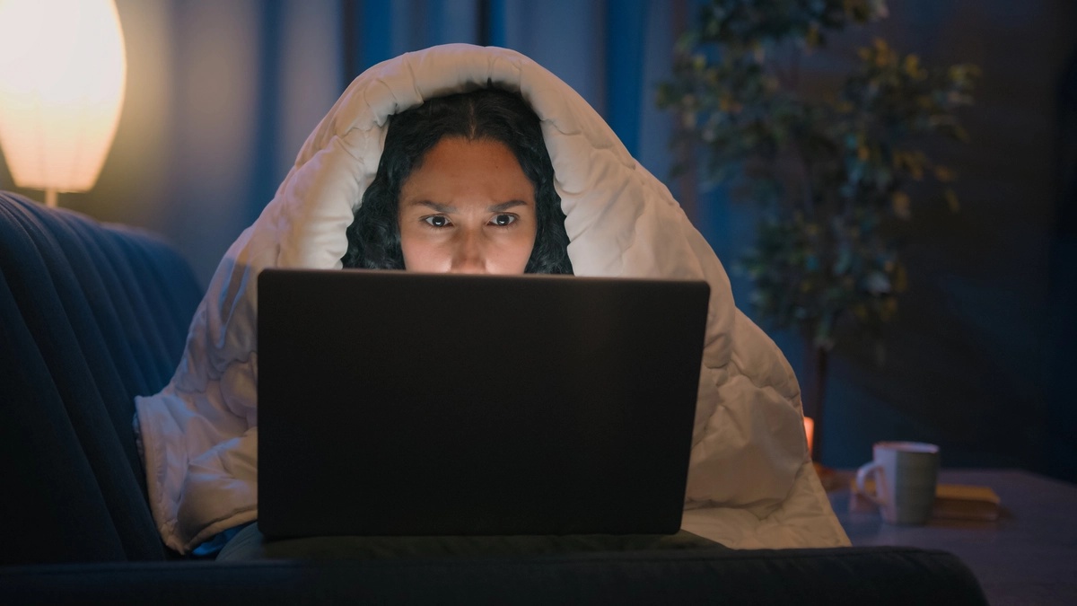 A woman staying up late on her laptop and suffering from internet addiction. A woman staying up late on her laptop and suffering from internet addiction.