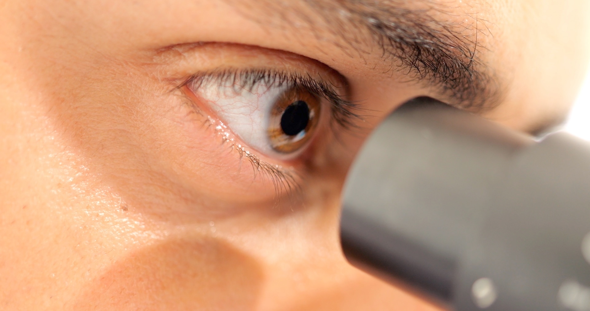 eye-of-professional-male-scientist-looking-through-2024-10-11-01-35-00-utc
