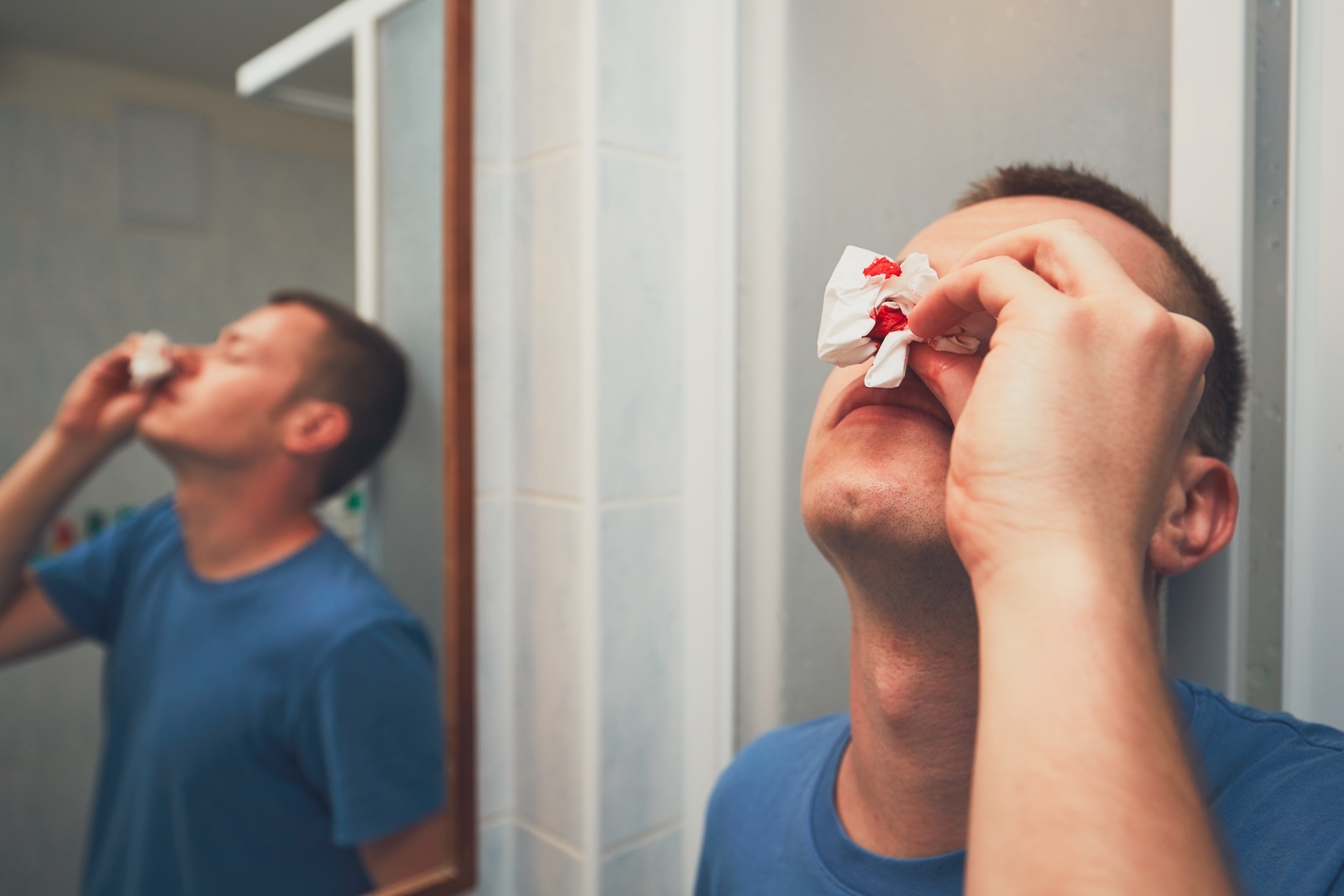 man-with-nose-bleed-in-bathroom-for-themes-of-illness