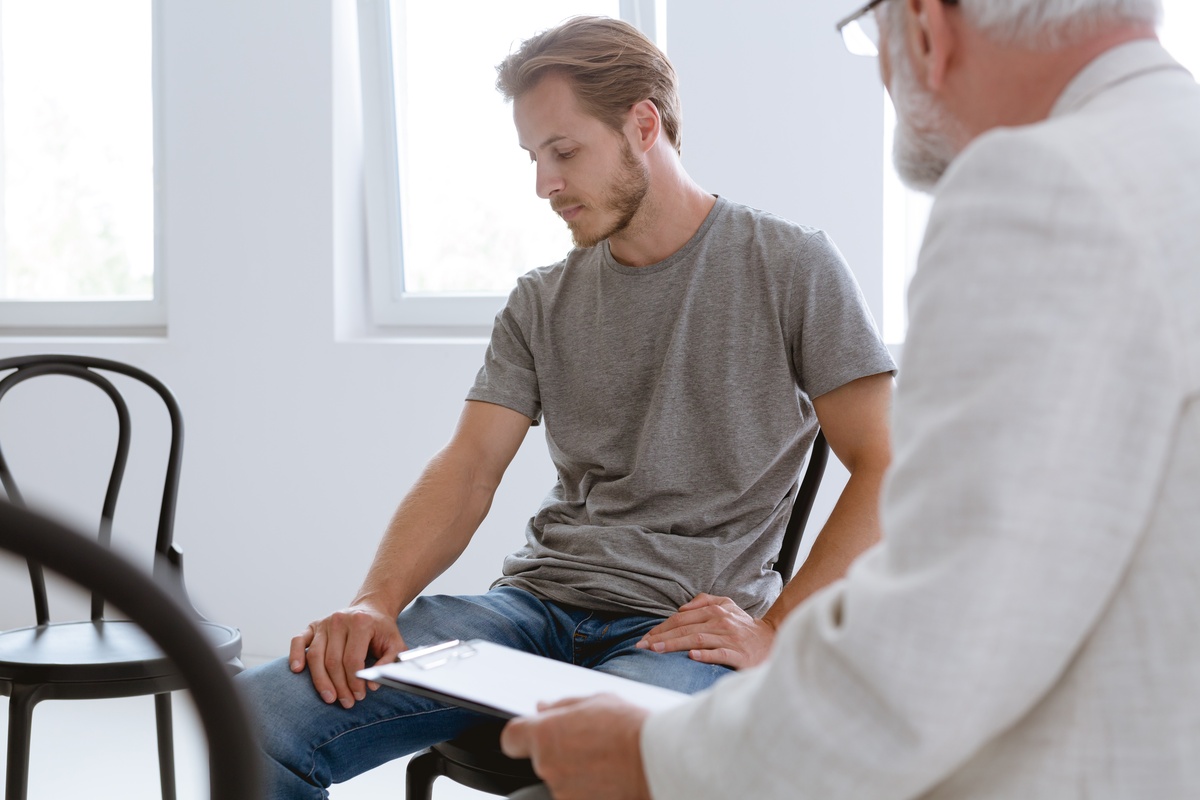 A man in an EMDR session with a therapist. A man in an EMDR session with a therapist.