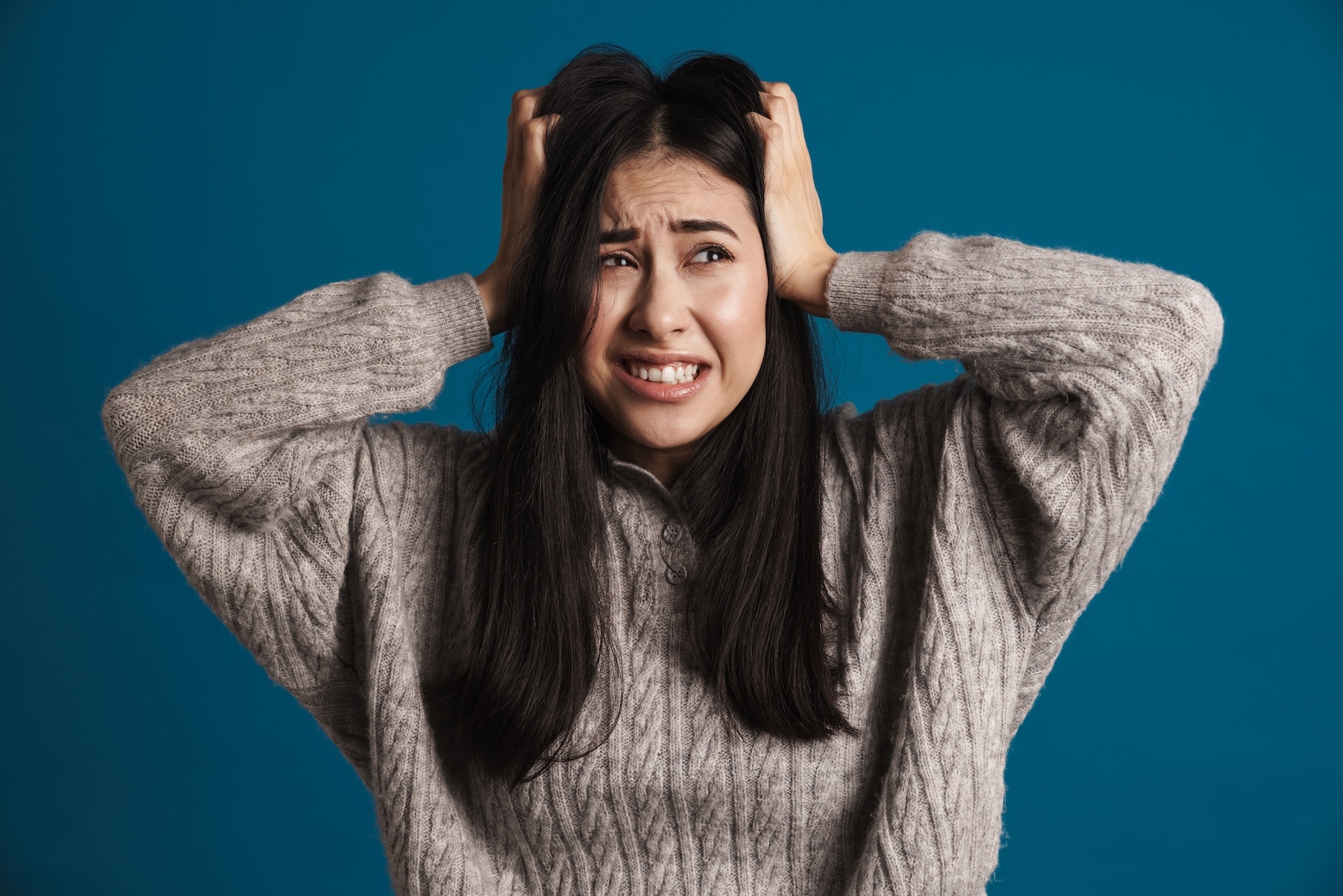 unhappy-beautiful-asian-girl-grabbing-her-head-and-2025-02-16-18-56-31-utc