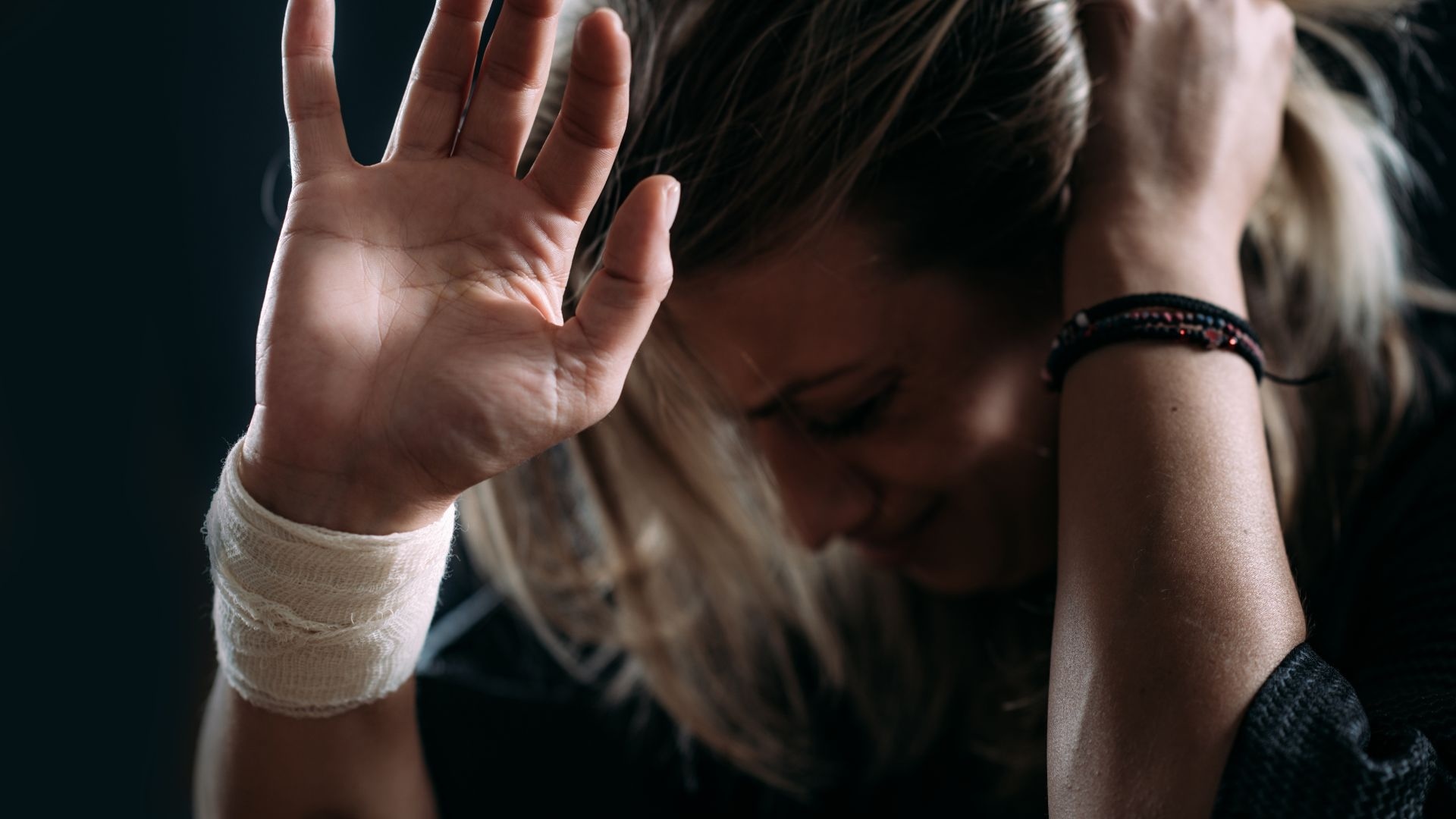 sh addiction: woman in dark room covering her head in fear sh addiction: woman in dark room covering her head in fear