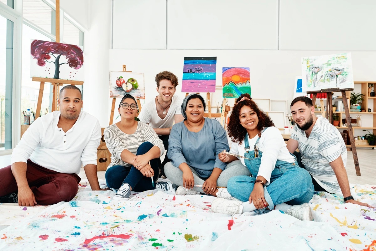 A group of people in recovery practicing art therapy, a form of experiential therapy. A group of people in recovery practicing art therapy, a form of experiential therapy.