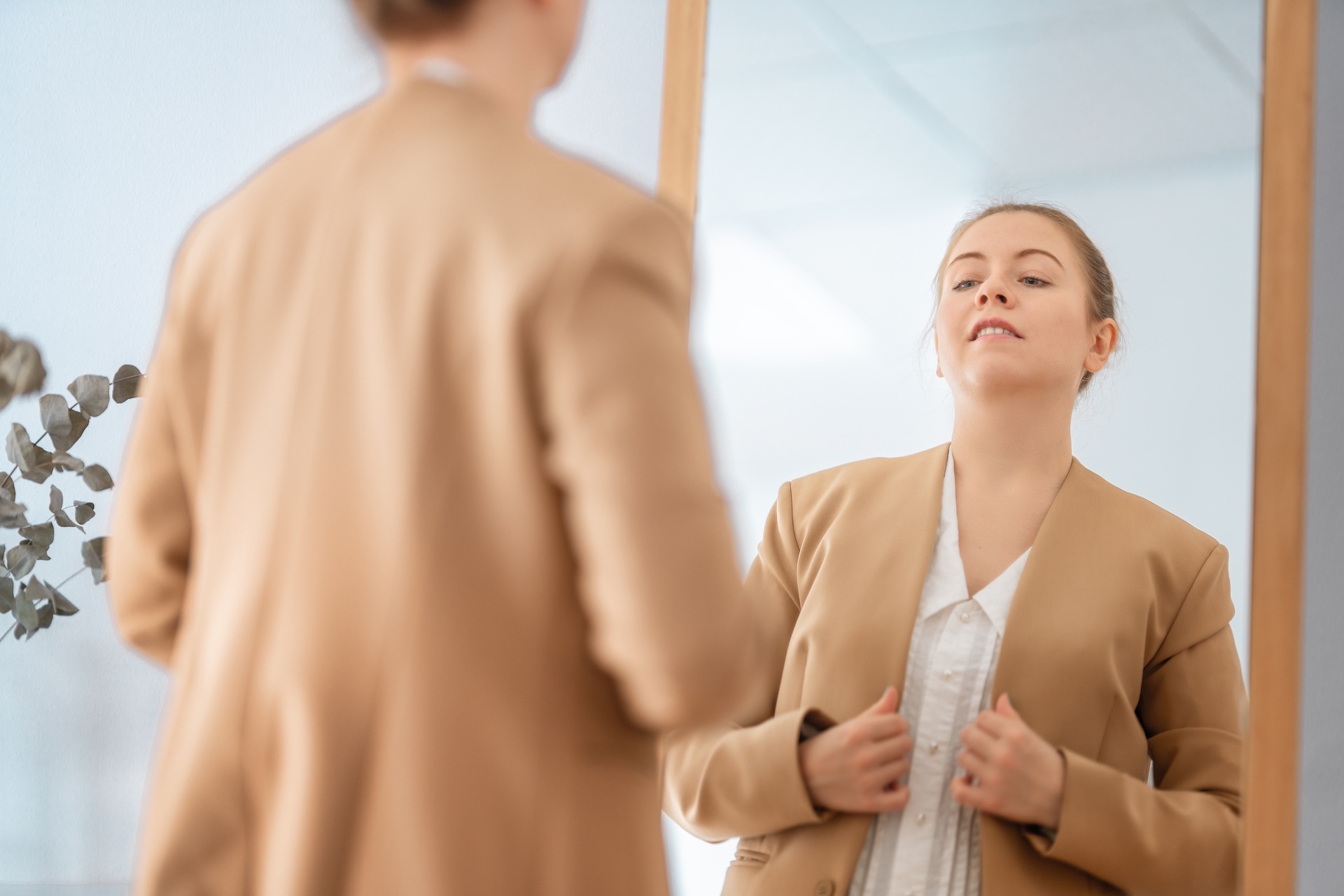 woman-looking-at-her-reflection-in-mirror-2024-11-05-09-37-21-utc