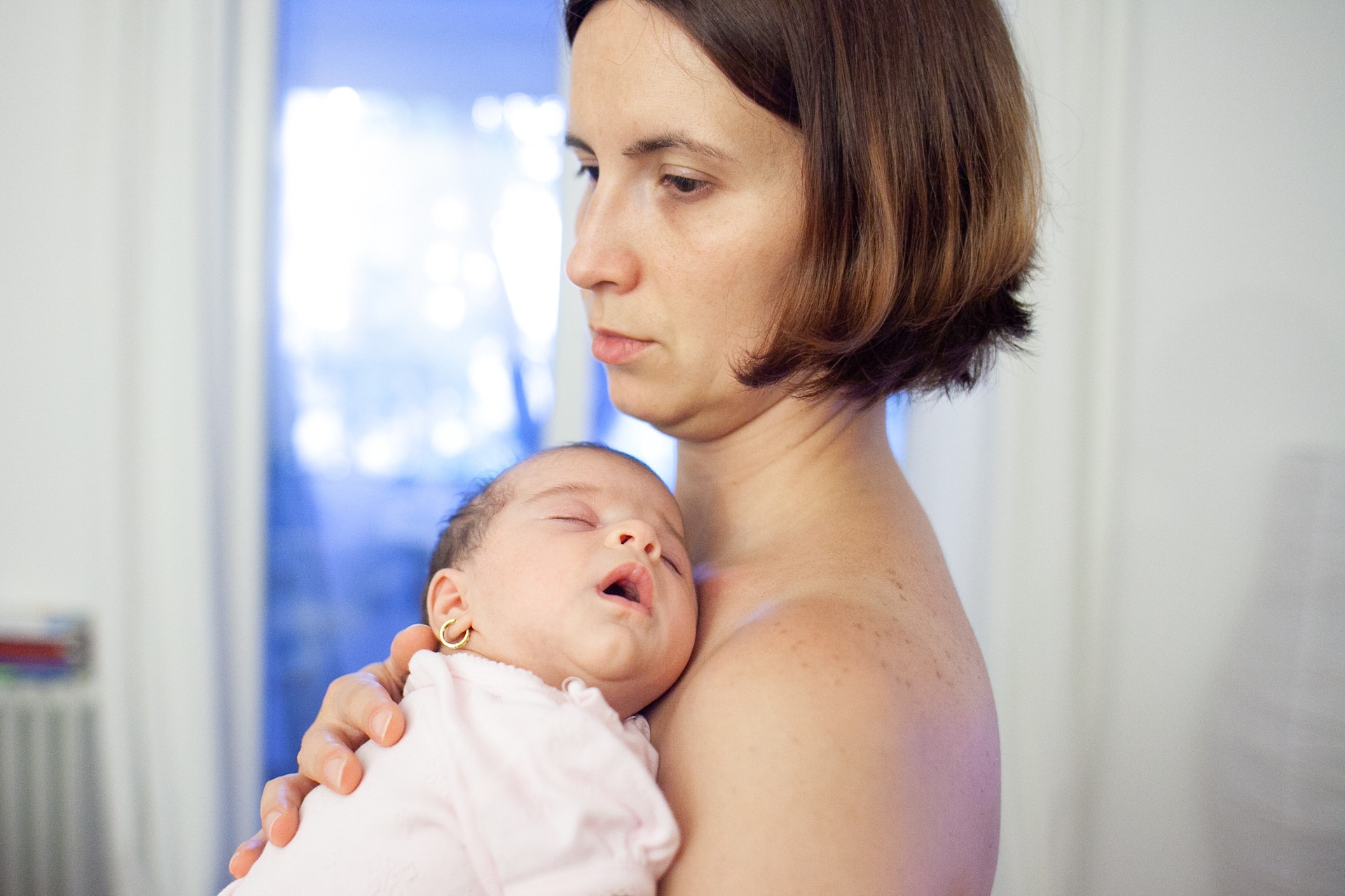 a-baby-girl-sleeps-in-her-mother-s-arms