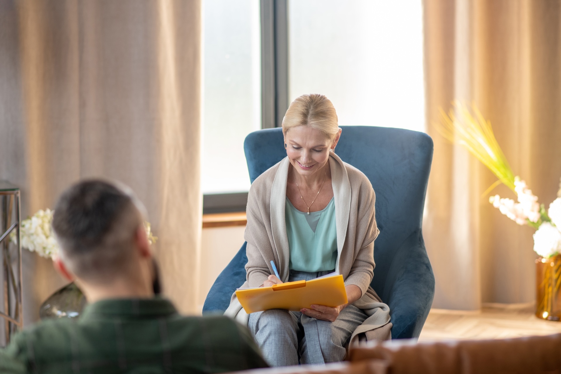 psychoanalyst-smiling-while-making-notes-and-talki-2024-10-18-05-09-43-utc