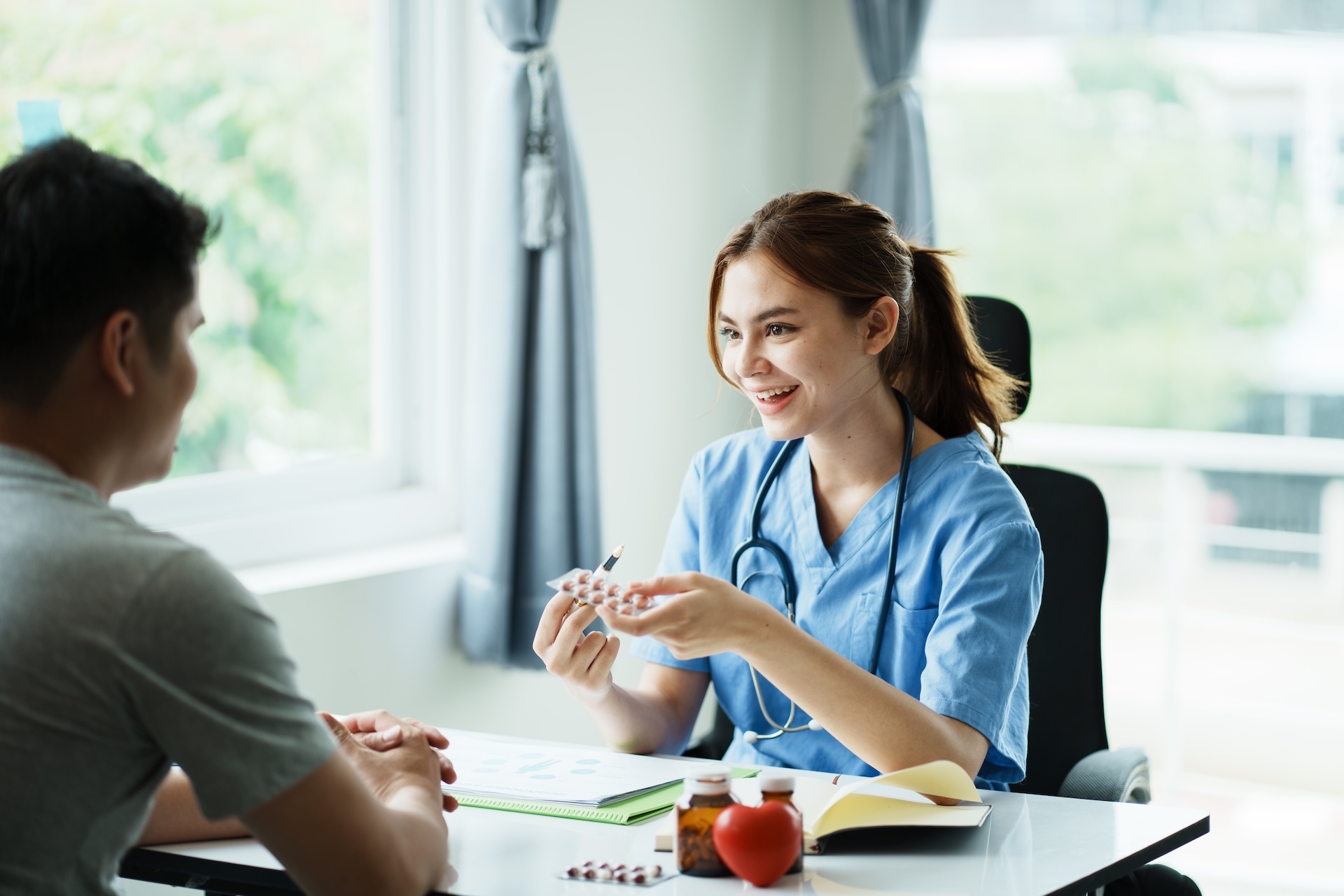 female-doctor-with-laptop-pc-computer-talking-to-m-2025-01-10-12-40-02-utc