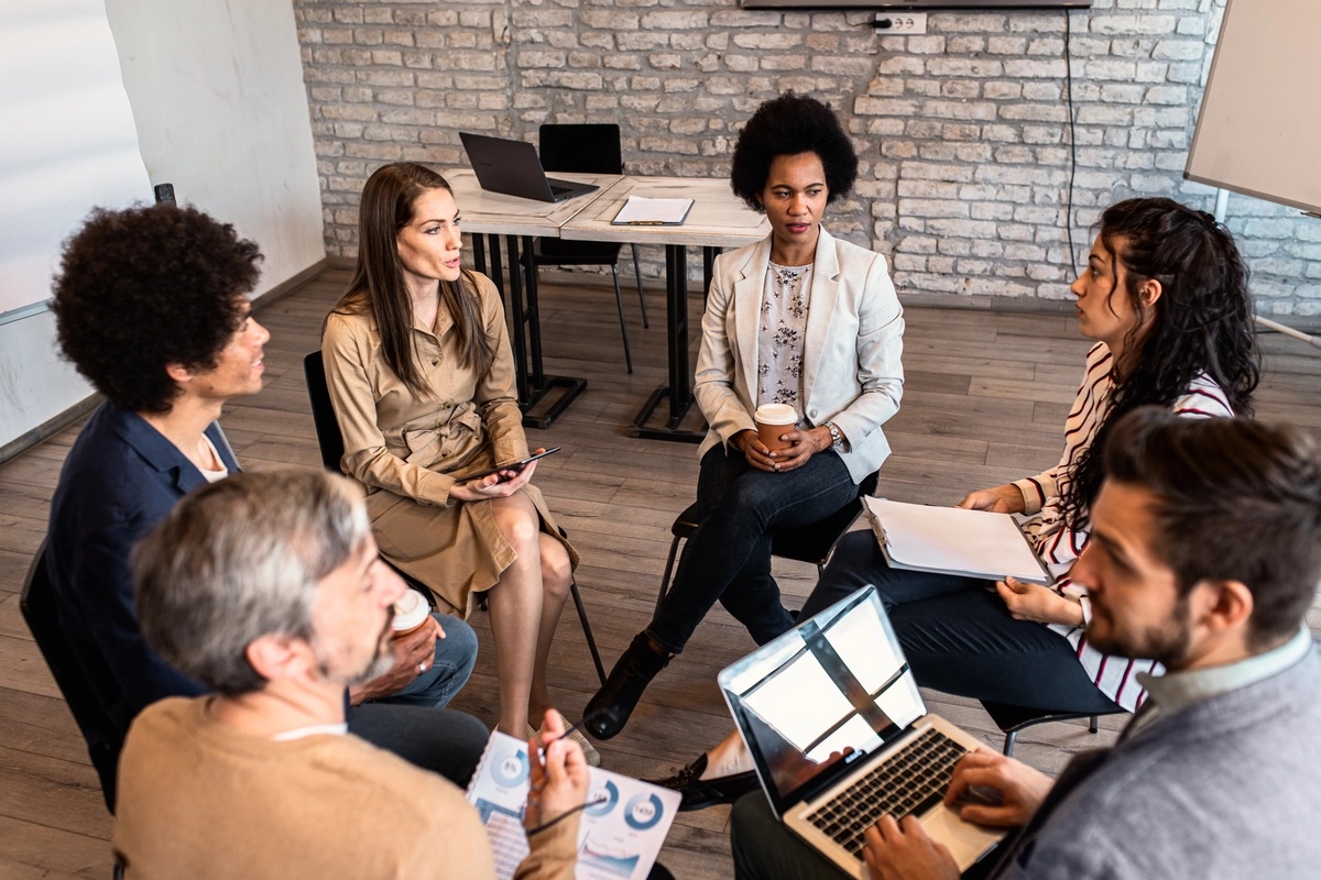 A group of case managers sitting in a circle. A group of case managers sitting in a circle.