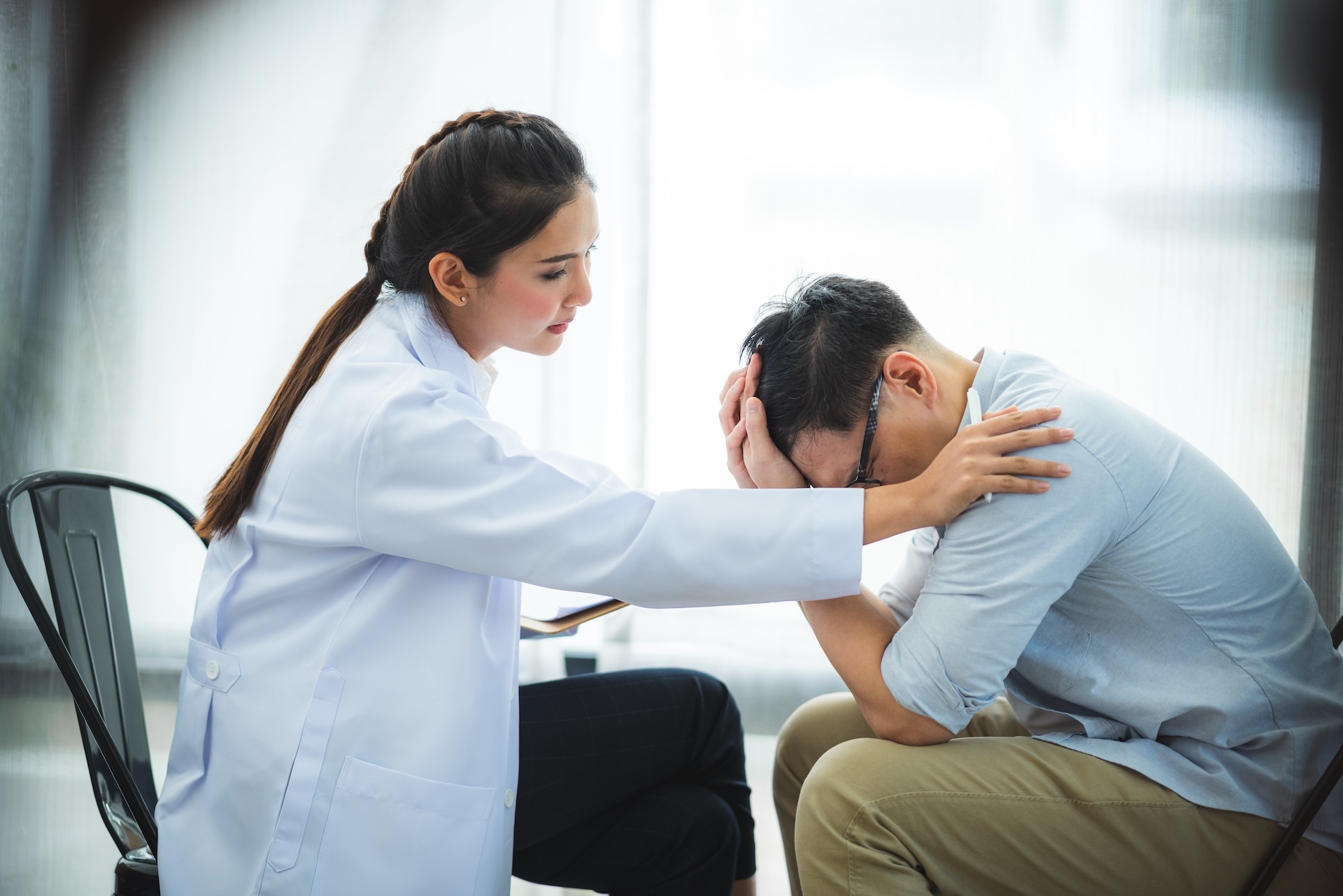 close-up-of-psychologist-comforting-his-depressed-2023-11-27-05-18-58-utc
